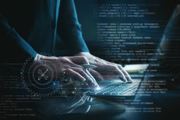 manager providing technical support on laptop using software.