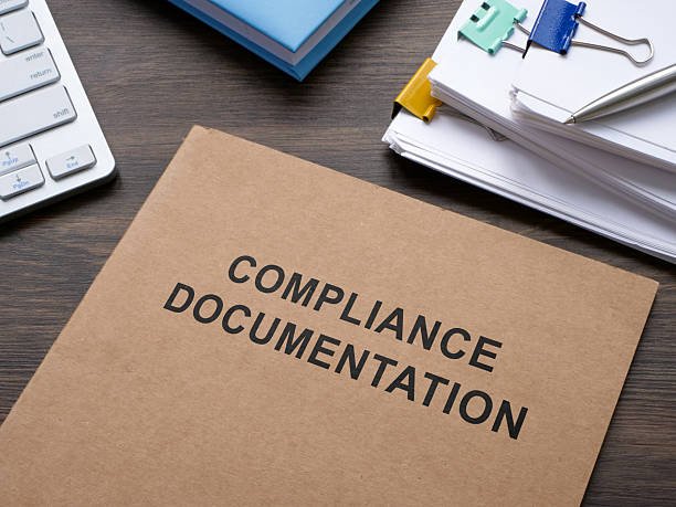 compliance documentation on the table.